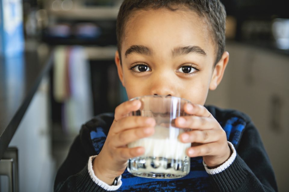 Boy drinking milk manufactured with oil-free technology